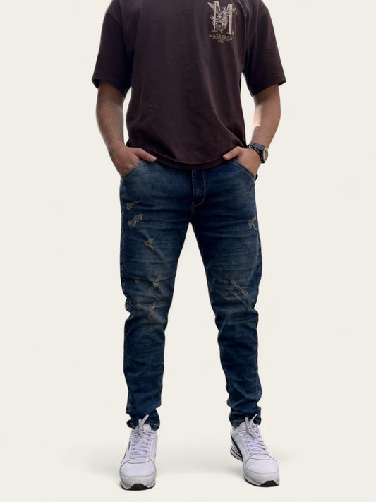 Jean slim clásico tono azul con rotos para hombre